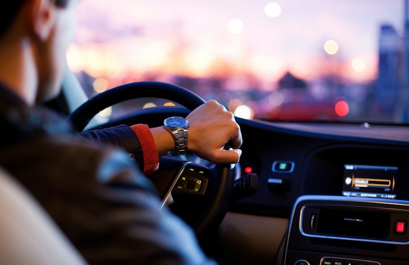 Driver's hands on a steering wheel