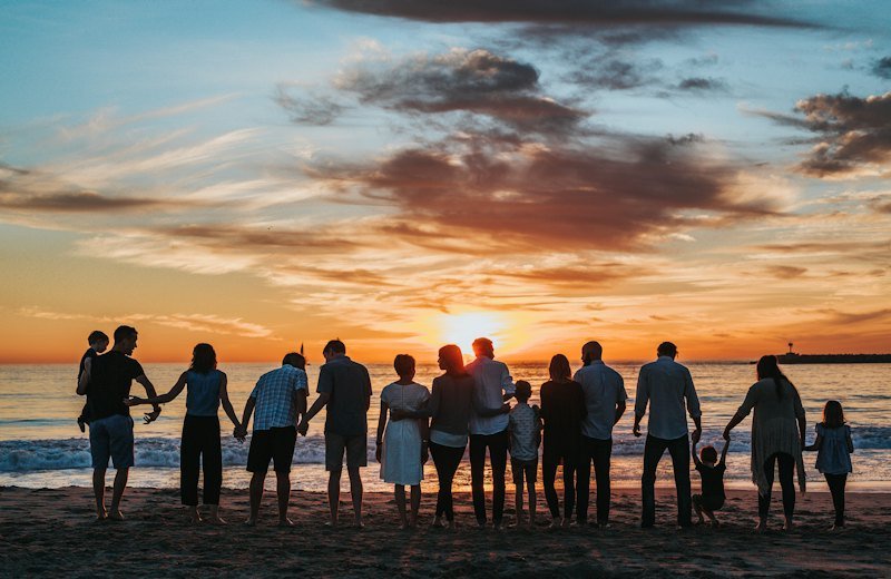 Family together on a beach at sunset
